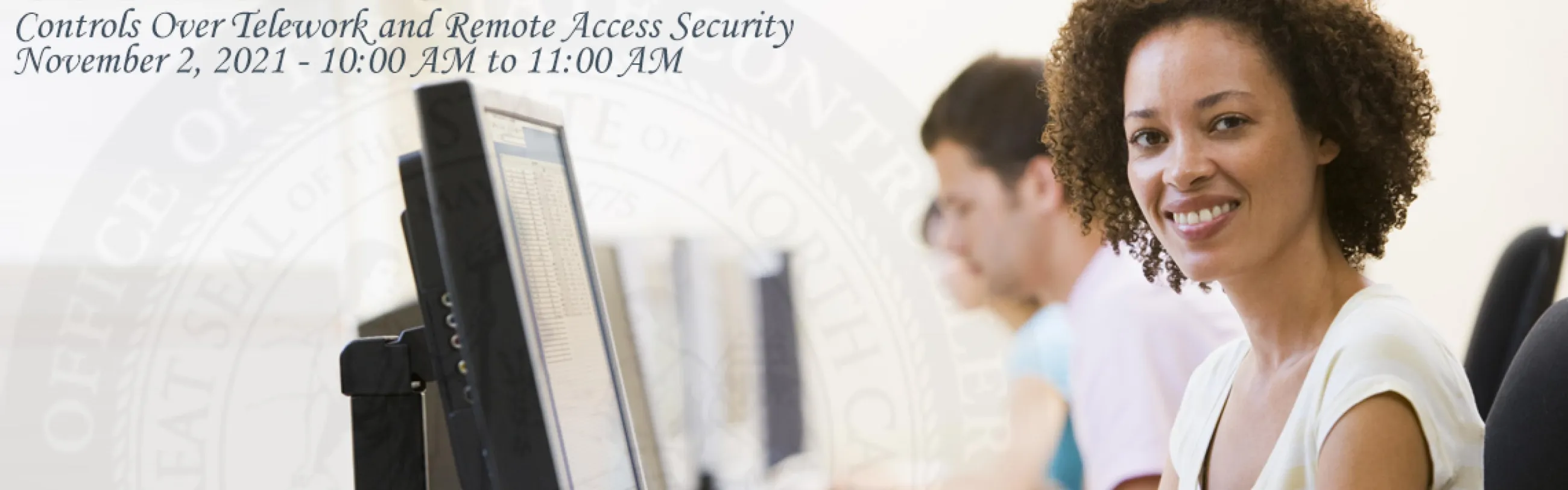 Stock Image: Woman smiles in front of a computer