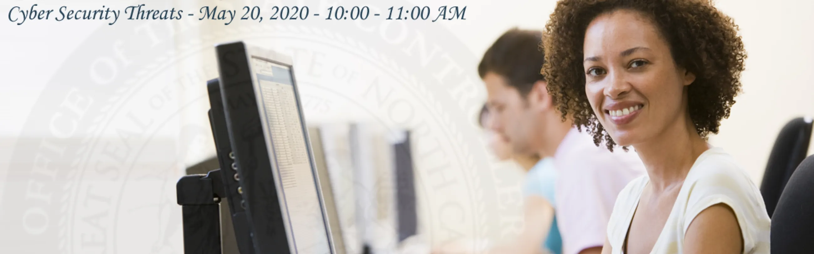 Stock Image: Woman smiles in front of a computer